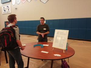 kory speaking to student at the career fair